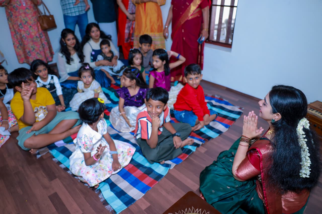 Sarvasri Sukesh teaching a music class to young children